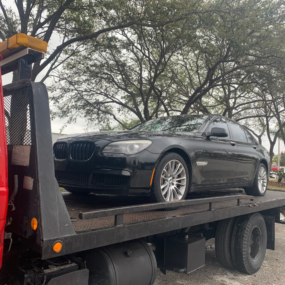 apopka towing and storage services - black bmw being towed